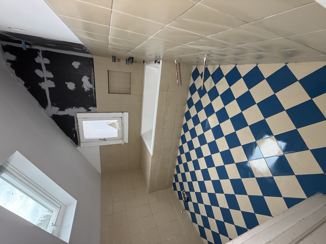 Attic bathroom with a blue checkerboard floor