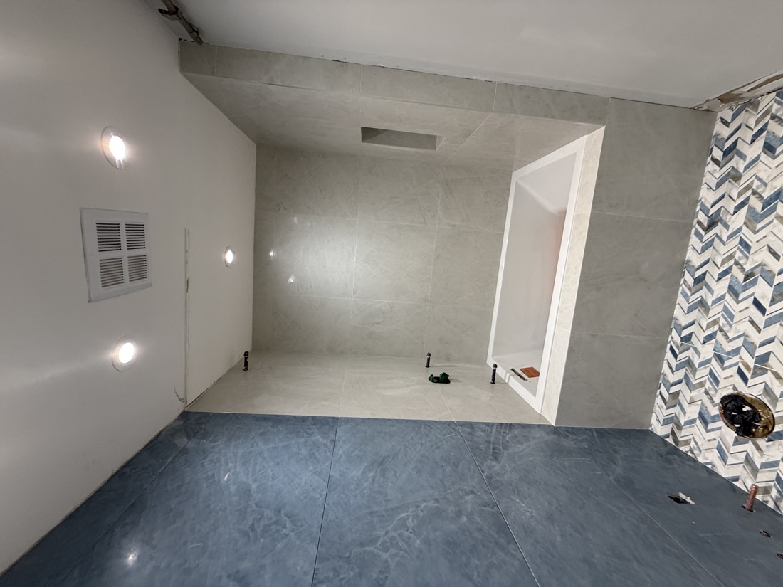 Herringbone tile floor with a tub surround