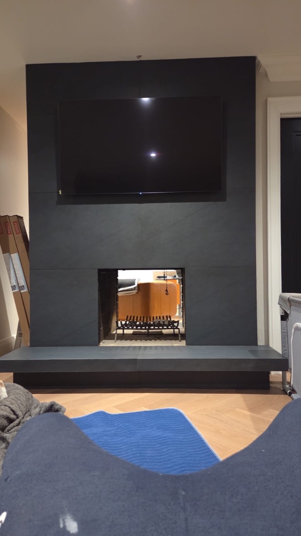 Black slab fireplace, floor to ceiling